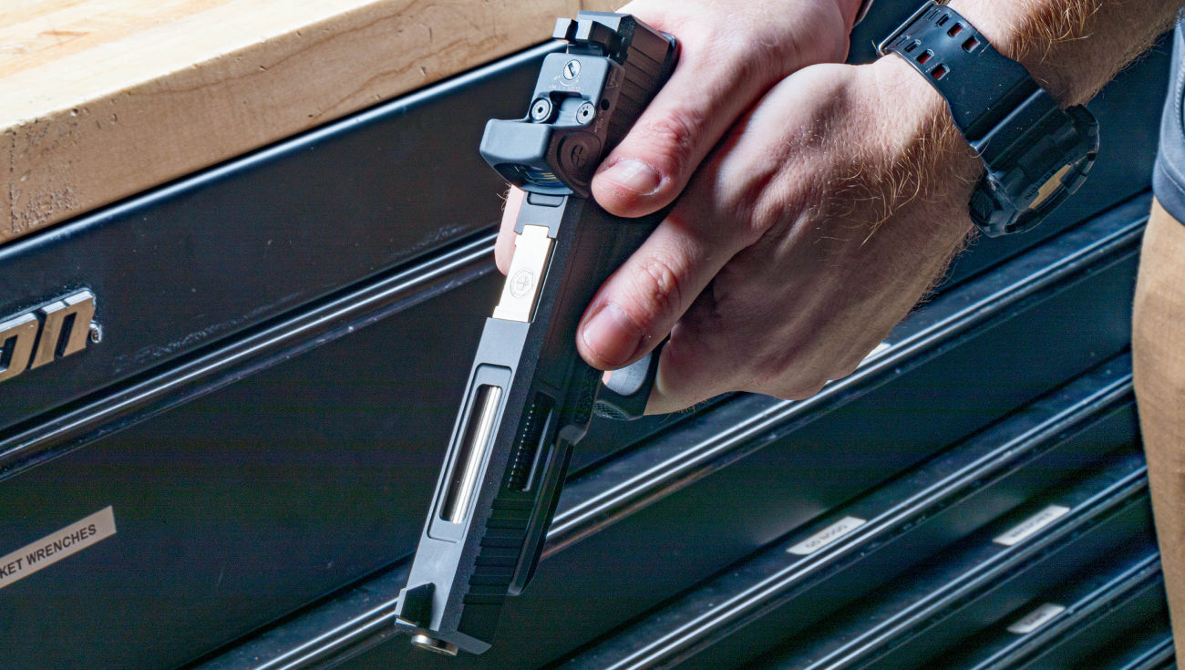 Gunsmith aims competition custom Glock 34 handgun after completing pistol build