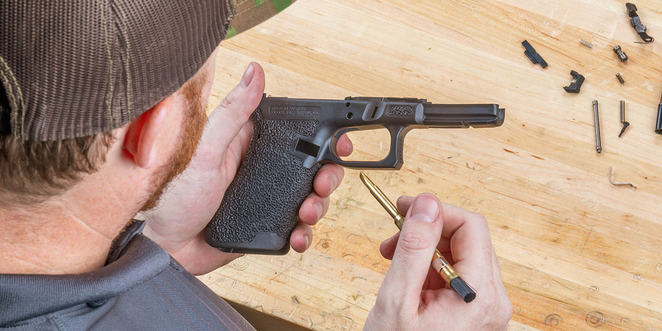 Gunsmith looks over Rook Customs Glock 17 Tier 1 frame before assembling Glock34 pistol